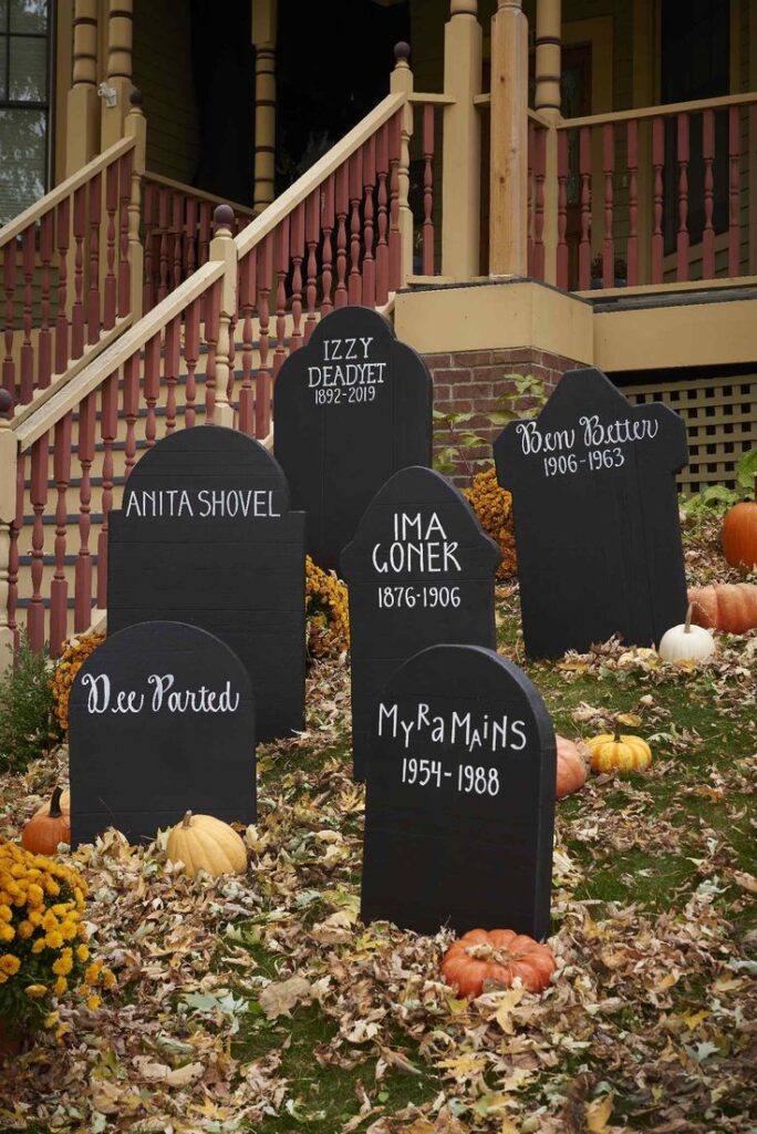 Handmade foam gravestones with funny or creepy epitaphs arranged in the front yard.