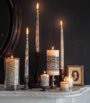 DIY candles made from painted toilet paper rolls with tea lights at the top.