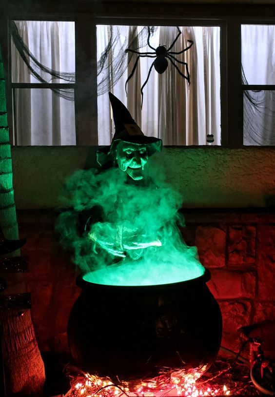 Cauldron with fog pouring out, surrounded by spooky artifacts for a haunted effect, ideal for patios or porches.