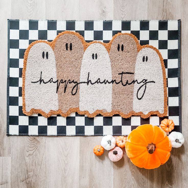 White-painted ghost on a doormat at the entrance to a home.