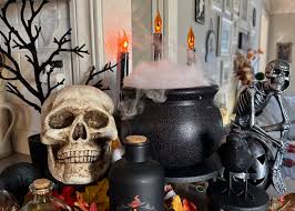 Cauldron with mist spilling out from a hidden fog machine, creating a ghostly atmosphere for haunted décor.