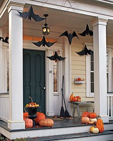 Paper bat cutouts suspended from the ceiling, creating the illusion of a bat swarm.