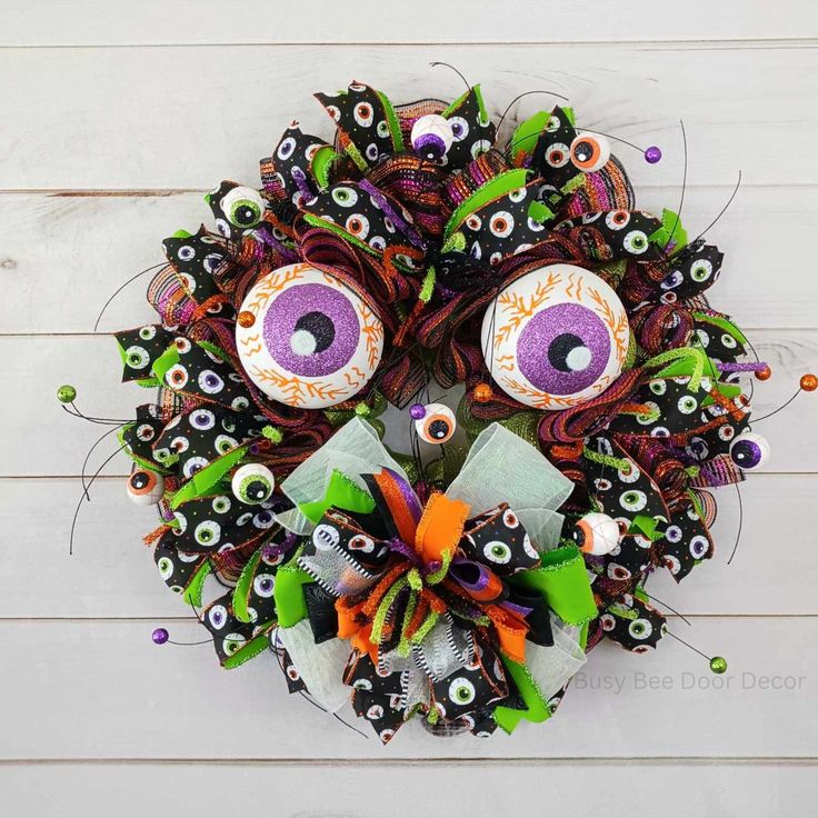 Wreath made from googly eyes in various sizes, with giant glowing eyes in the center.