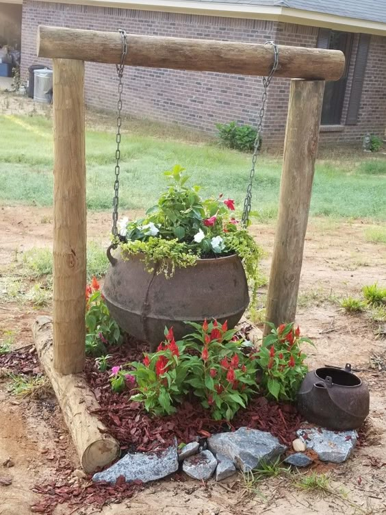 Rustic cauldron filled with moss, tiny fairies, and gnome figures, adding a magical woodland vibe to any garden.