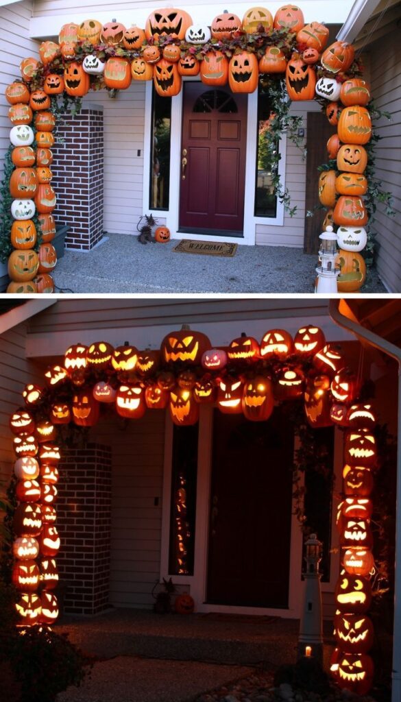 Fake vines and pumpkins forming a lighted archway leading to a doorway.